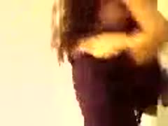 A curvy 27-year-old Egyptian girlfriend dances while wearing a tight purple dress.